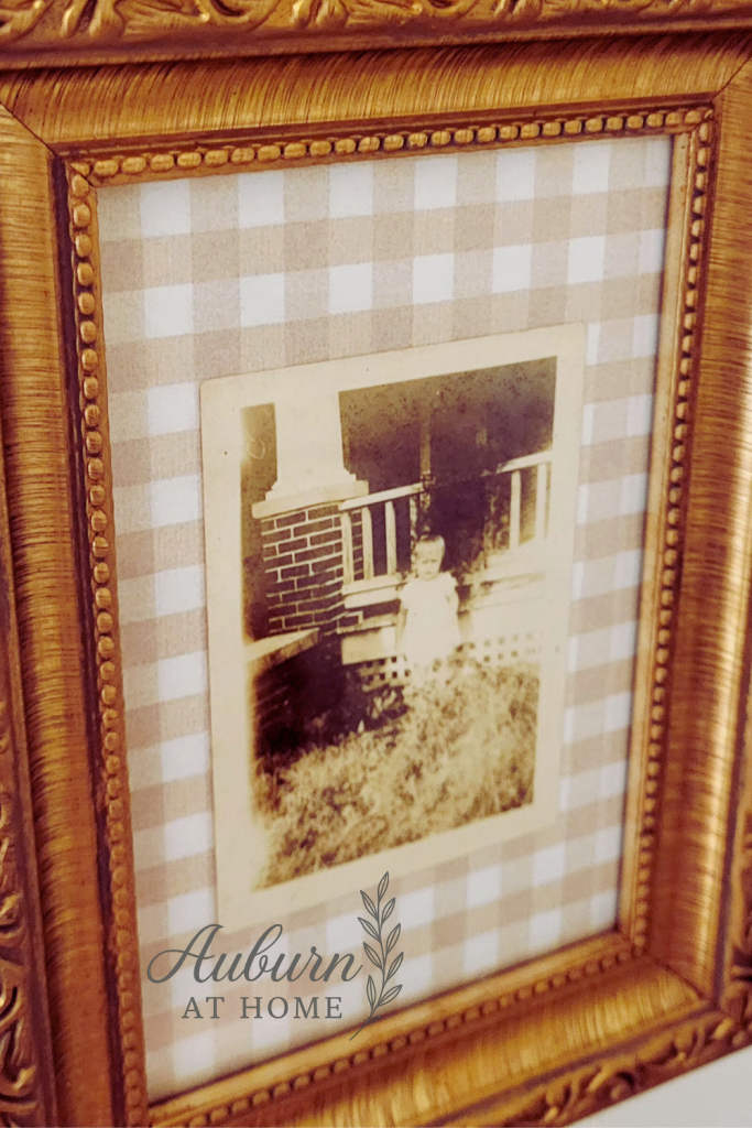 Vintage frame on collage wall. Vintage brass picture frame with gingham background