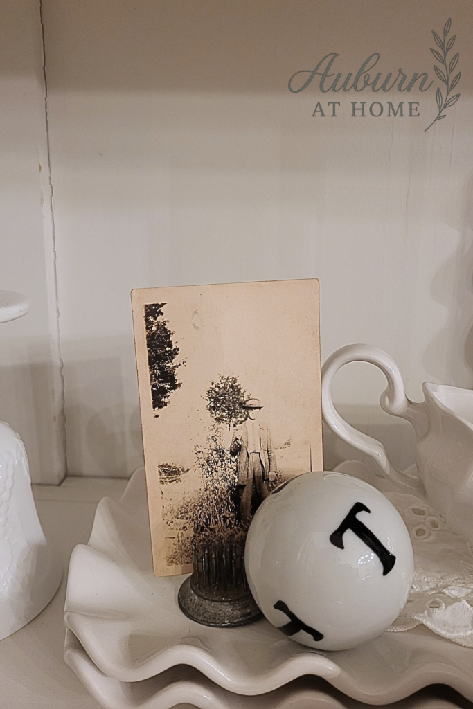 Farmhouse decor. Vintage pictures on shelf. 