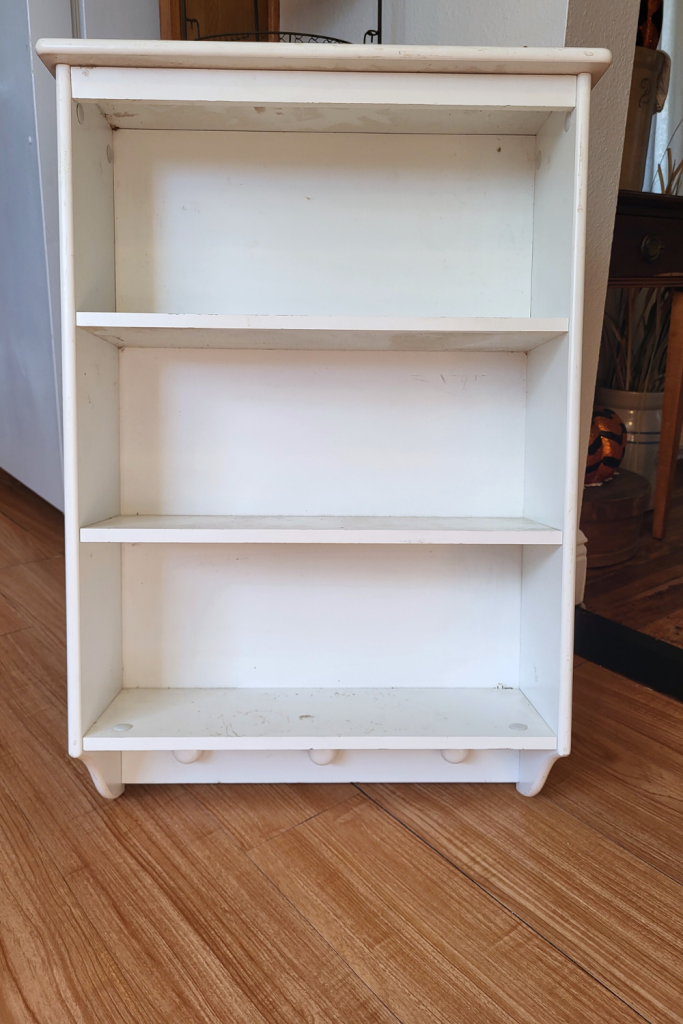 Thrifted shelf before makeover. Cute farmhouse styling idea.