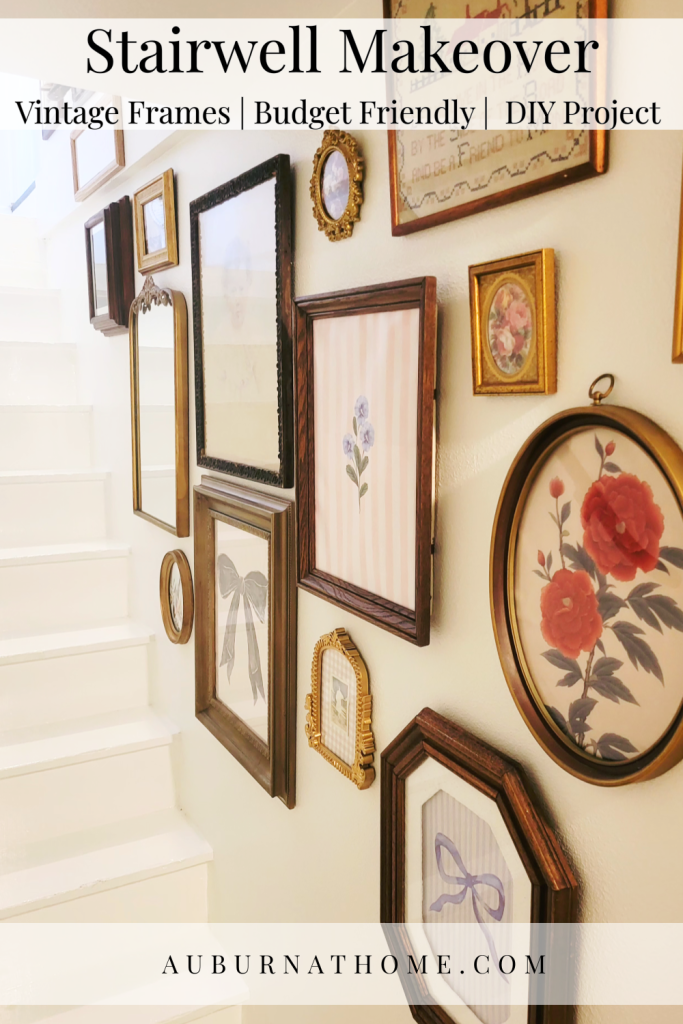 Before photo of the stairwell with worn pink carpet on the steps and simple fall décor arranged along the side, showing the starting point before the makeover.