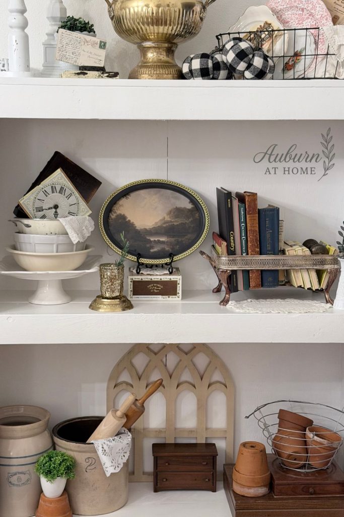 Farmhouse shelf with vintage crocks and terra cotta pot