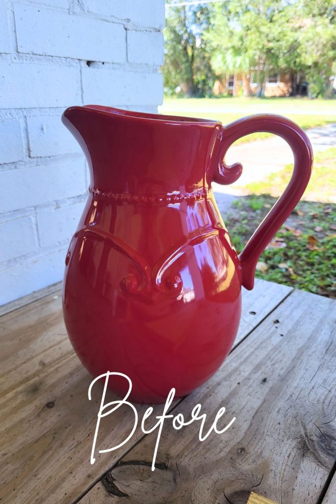Red ceramic thrifted pitcher before DIY farmhouse makeover.