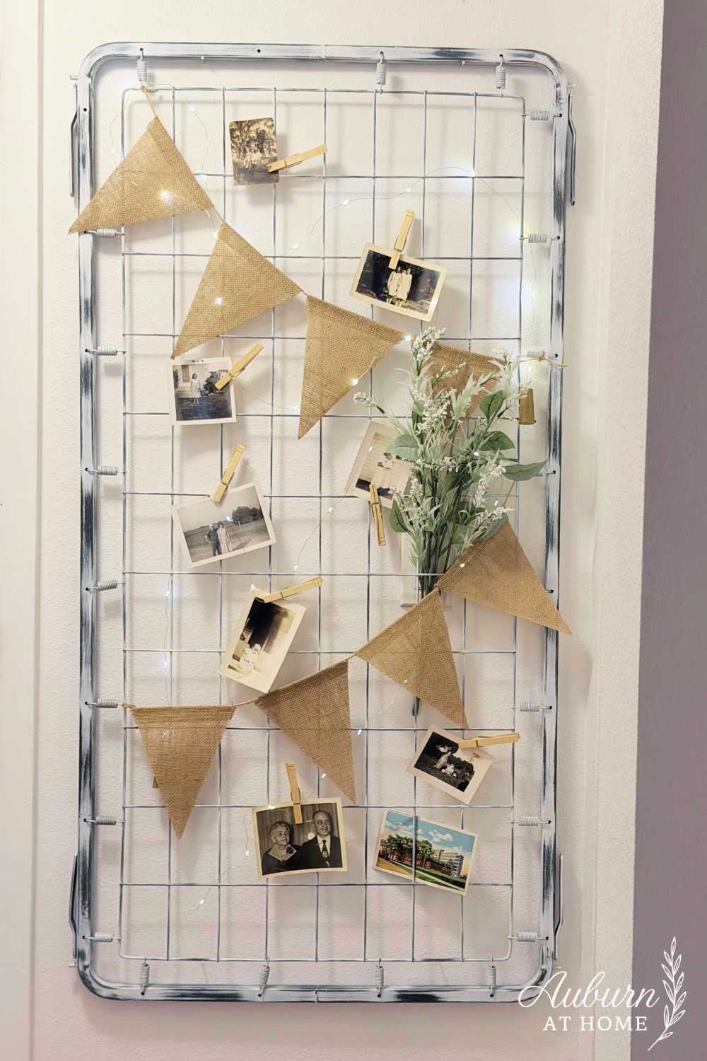 DIY wall decor made from a vintage crib spring with burlap bunting and black-and-white photos