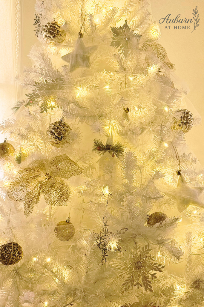White Christmas tree decorated with gold and silver ornaments, fluffed using Poly-Fil for a fuller and more elegant holiday look.