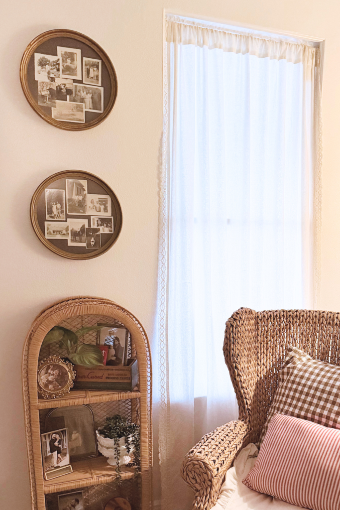 Vintage wall decor featuring thrifted frames and repurposed crewel embroidery styled in a cozy living room