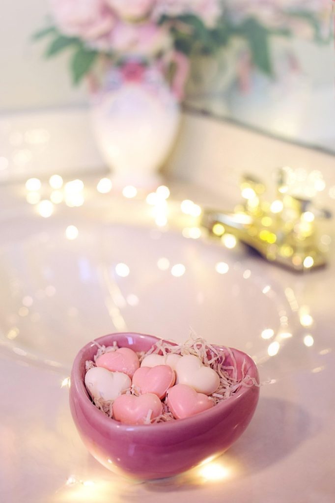 Heart bowl with mini-Valentine soaps with fairy light background