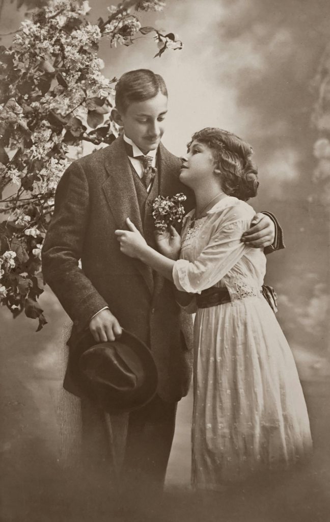 Antique black-and-white photograph of a romantic couple embracing, evoking vintage Valentine’s Day charm